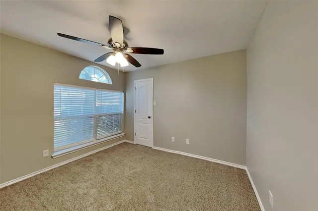a view of room with window and ceiling fan