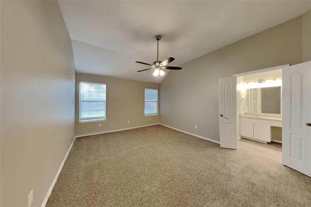 a view of a room with a windows and ceiling fan