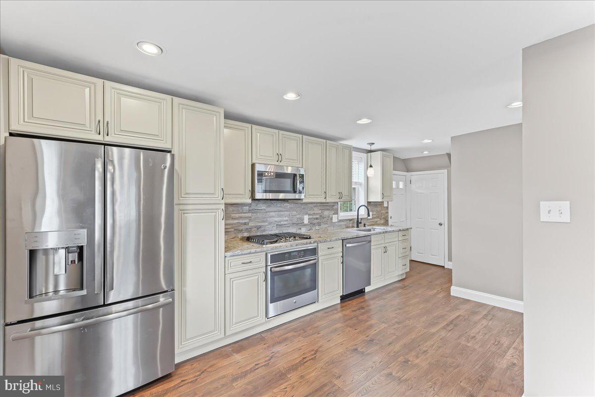 200 Fairview Road Springfield, PA 19064 - Photo 15 of 43 a kitchen with stainless steel appliances granite countertop a refrigerator and a stove top oven