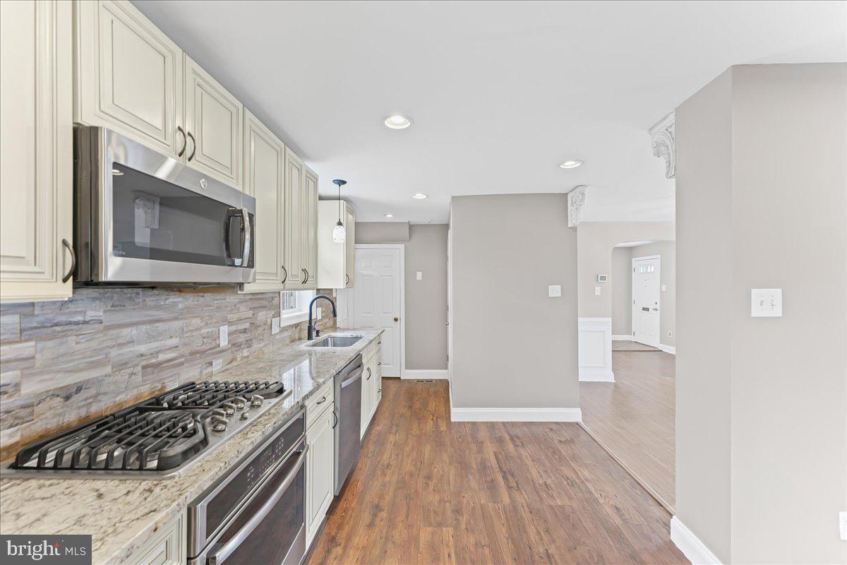 200 Fairview Road Springfield, PA 19064 - Photo 19 of 43 a kitchen with stainless steel appliances granite countertop a stove and a refrigerator