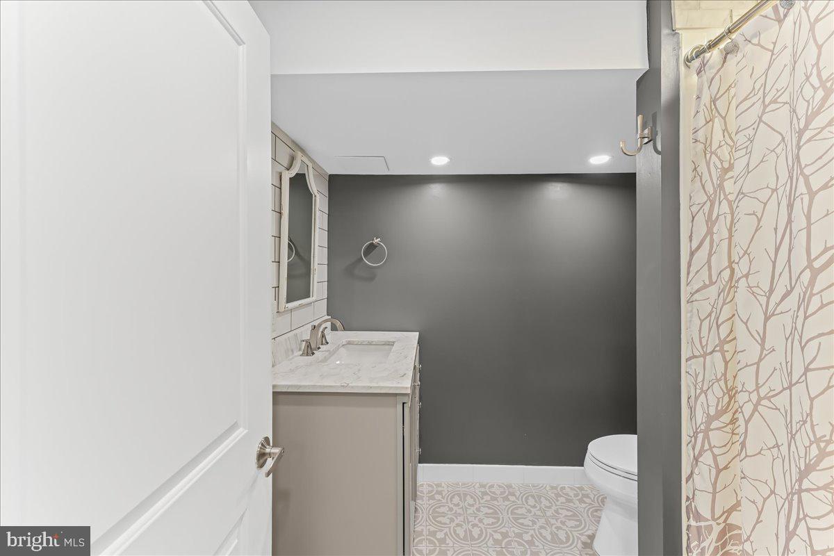 200 Fairview Road Springfield, PA 19064 - Photo 21 of 43 a bathroom with a sink and a mirror
