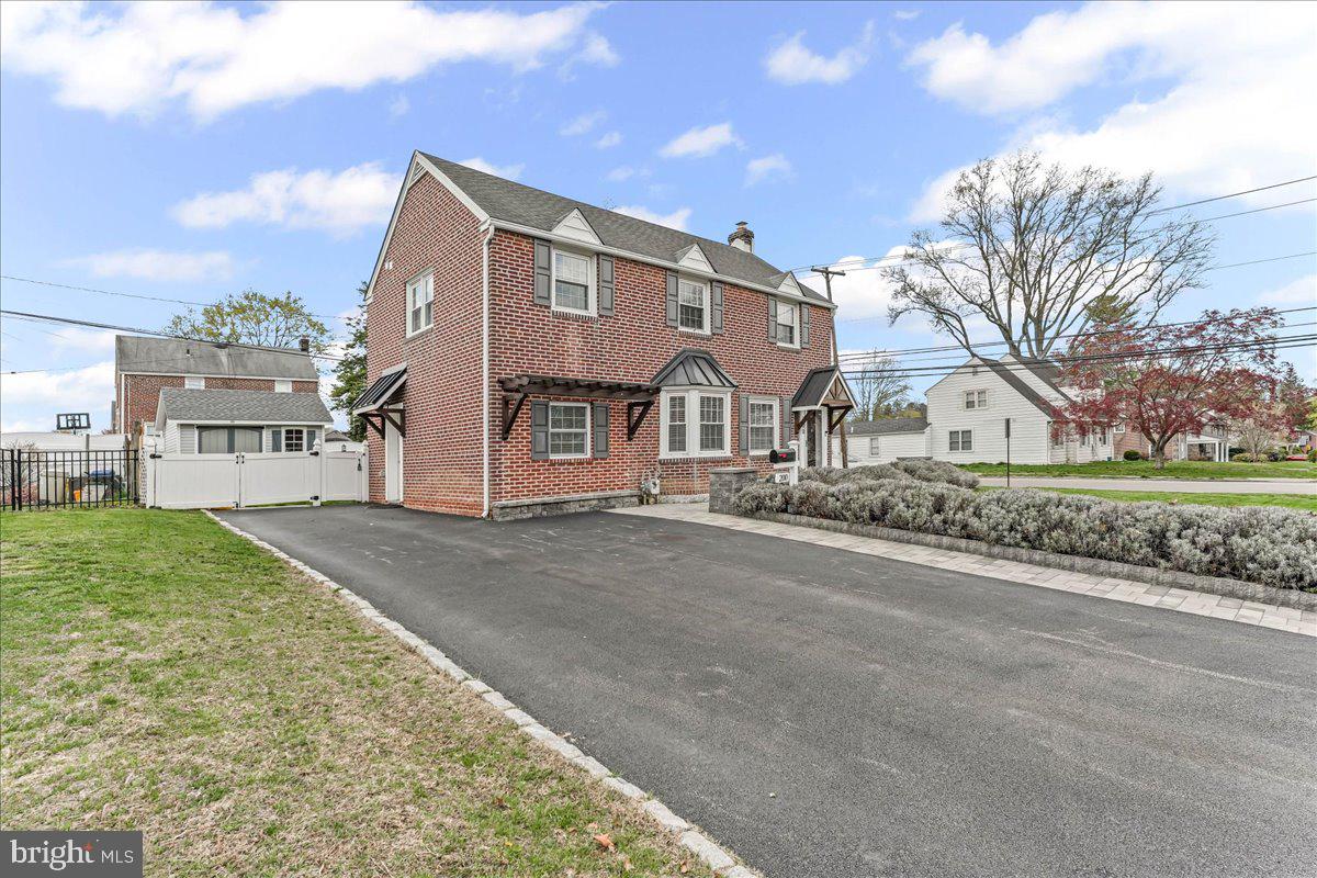 200 Fairview Road Springfield, PA 19064 - Photo 3 of 43 a front view of a house with a garden and tree