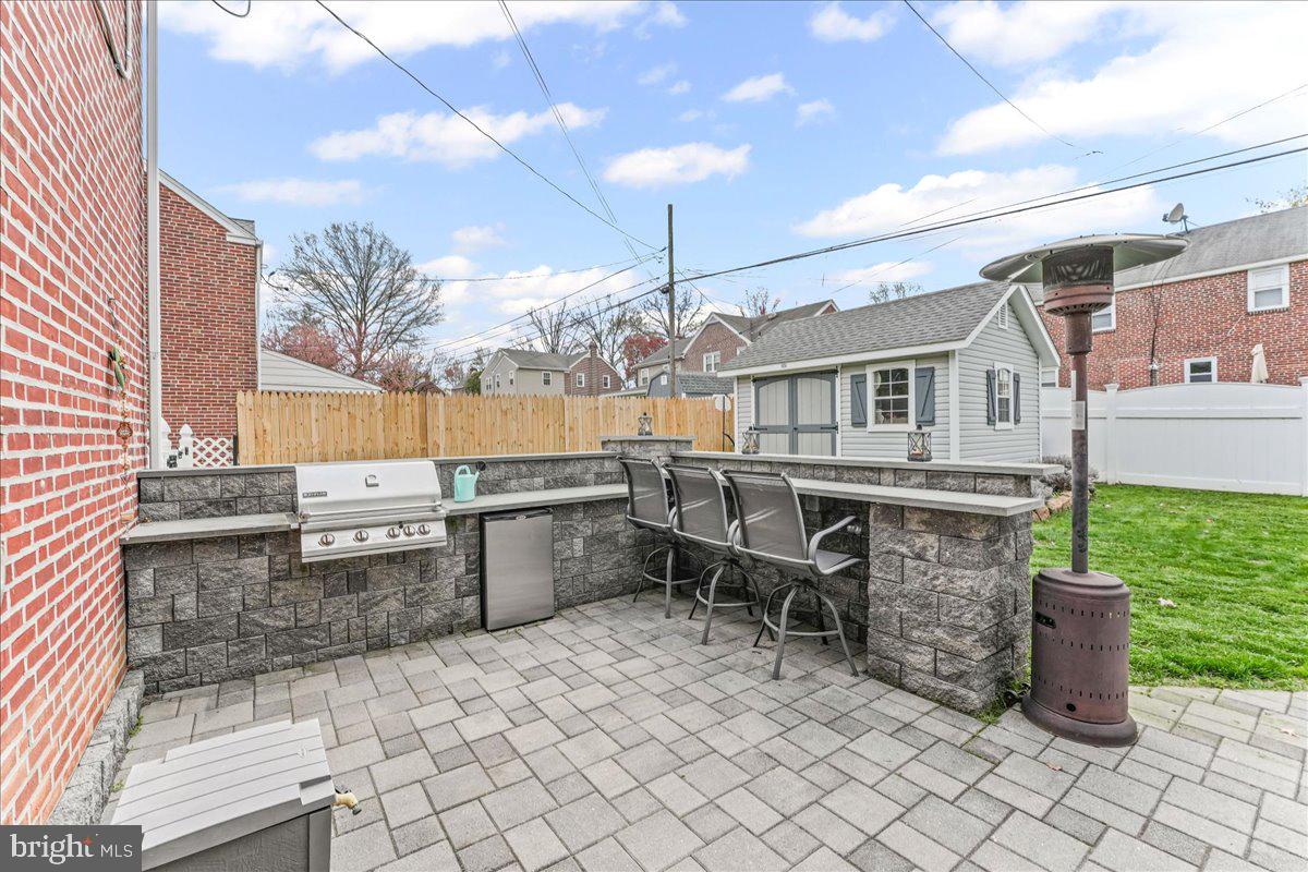 200 Fairview Road Springfield, PA 19064 - Photo 36 of 43 a view of a patio with a dining table and chairs with wooden floor