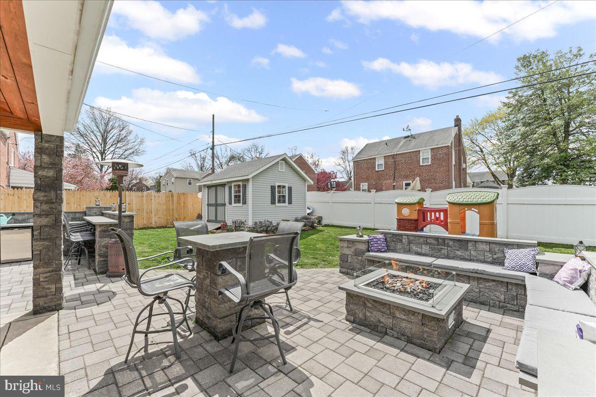 200 Fairview Road Springfield, PA 19064 - Photo 37 of 43 a view of a patio with a dining table and chairs with wooden floor