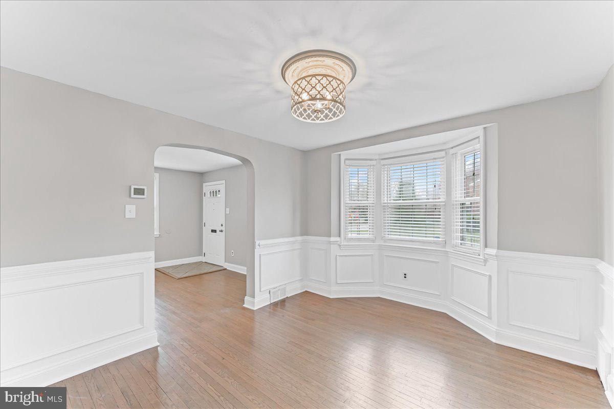 200 Fairview Road Springfield, PA 19064 - Photo 9 of 43 an empty room with wooden floor and white walls