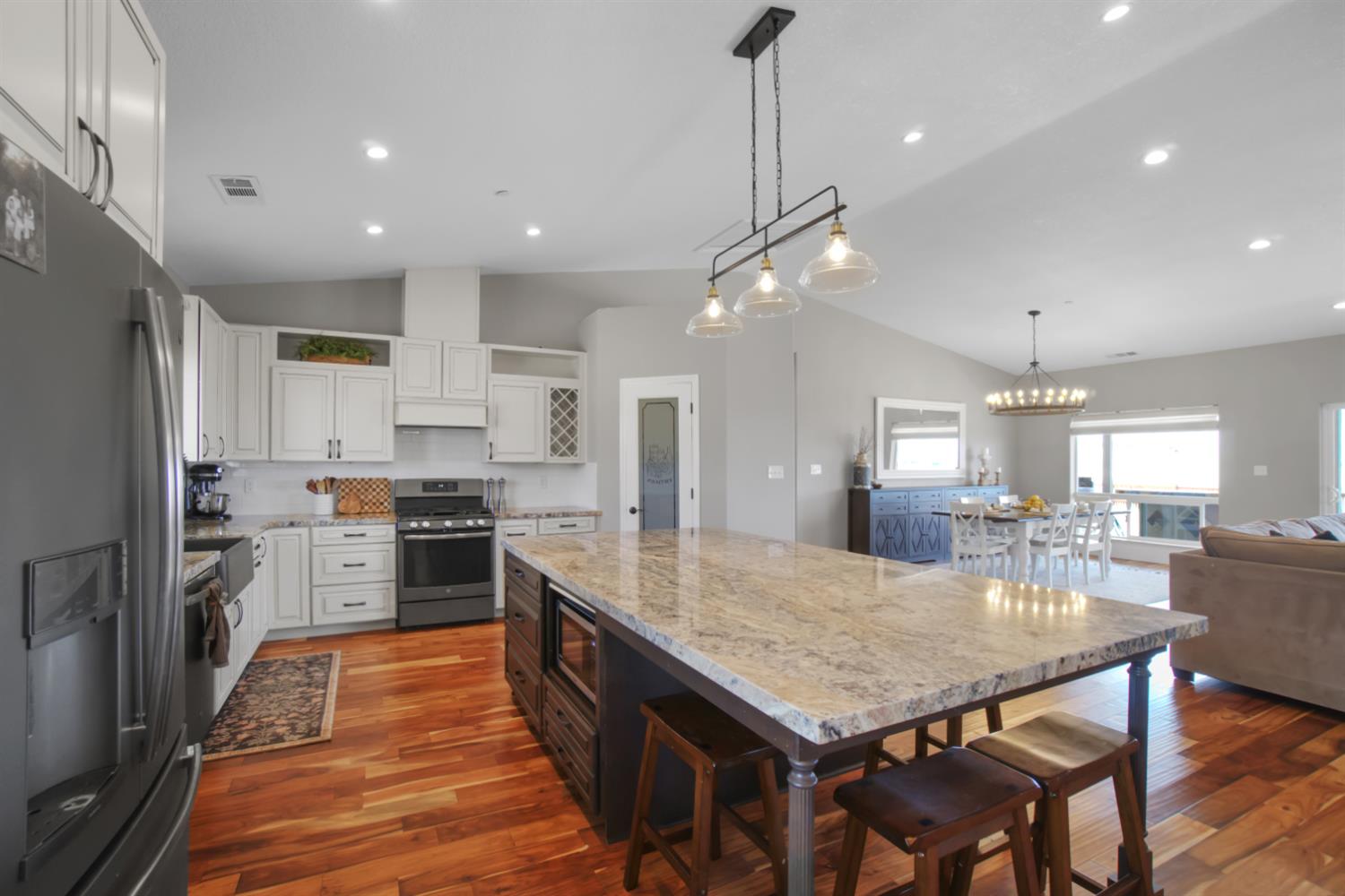 7991 South Shingle Road Shingle Springs, CA 95682 - Photo 12 of 58 a kitchen with granite countertop center island stainless steel appliances cabinets and a counter top space
