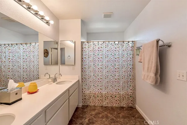 a bathroom with a sink mirror and shower