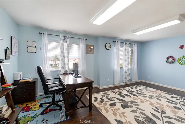 a view of a workspace with furniture and a window