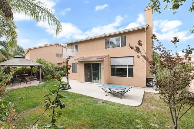a view of a house with backyard porch and sitting area