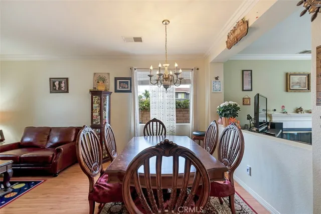 a view of a dining room with furniture and chandelier