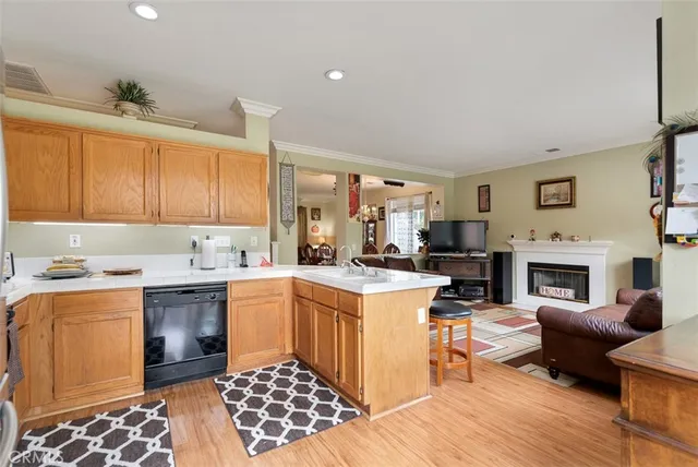 a open kitchen with stainless steel appliances granite countertop a stove and a sink