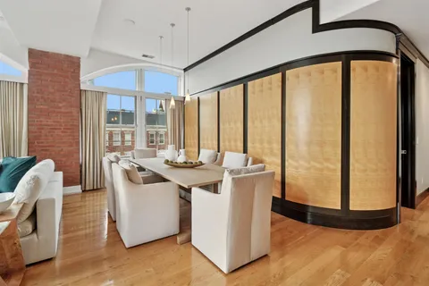 a view of a living room and kitchen with a large window