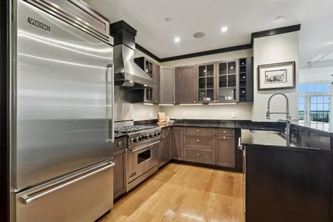 a kitchen with stainless steel appliances granite countertop a stove and a sink
