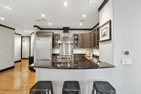 a kitchen with stainless steel appliances a refrigerator and a stove top oven