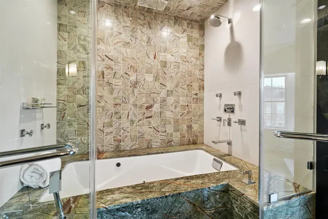 a bathroom with a bathtub and shower