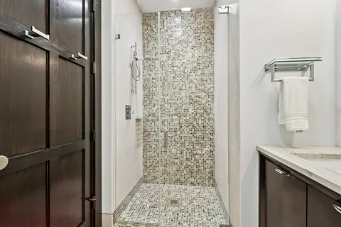 a bathroom with a granite countertop shower mirror and a sink