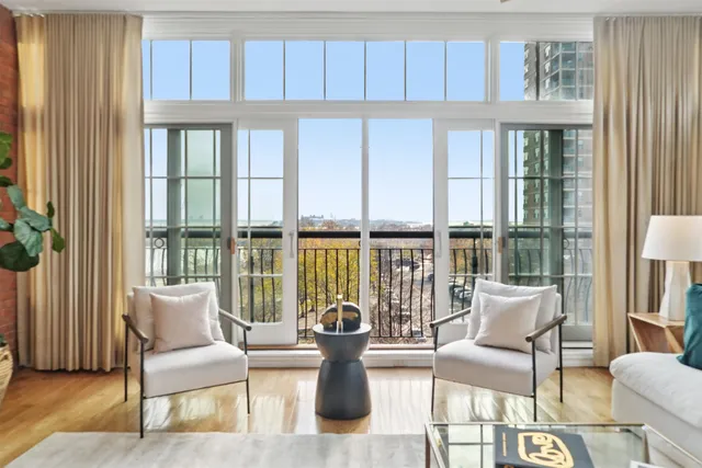 a living room with furniture and large windows