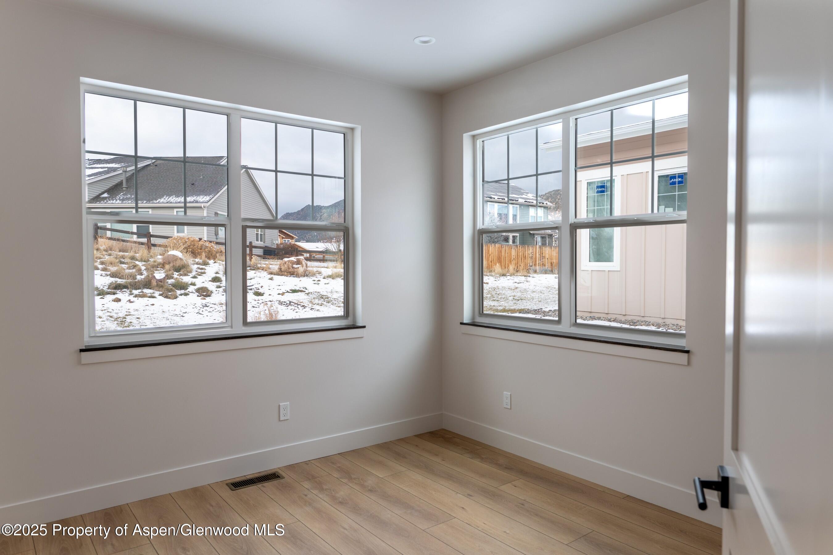 42 Mount Yale Court New Castle, CO 81647 - Photo 14 of 26 an empty room with wooden floor and windows