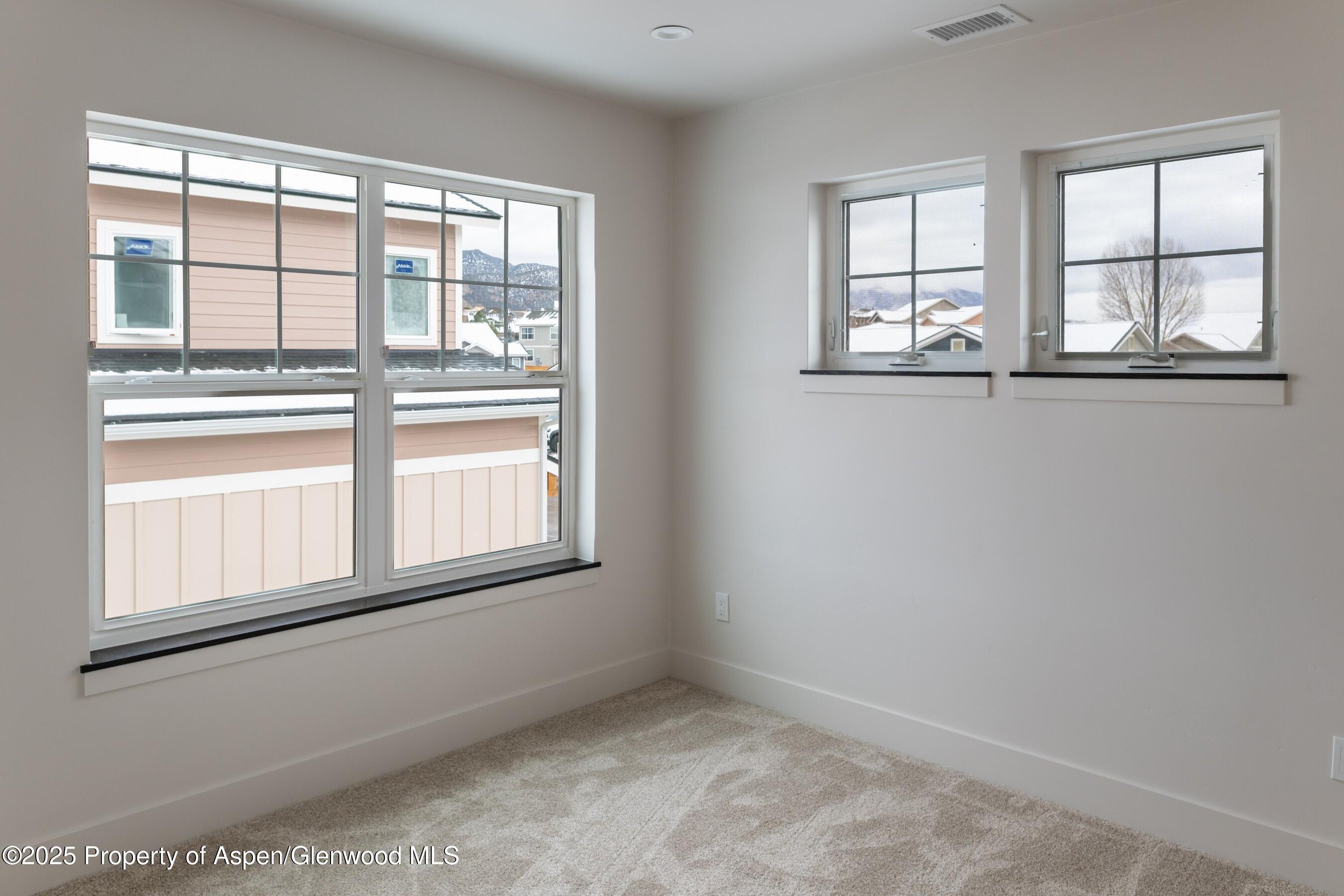 42 Mount Yale Court New Castle, CO 81647 - Photo 17 of 26 an empty room with wooden floor and windows
