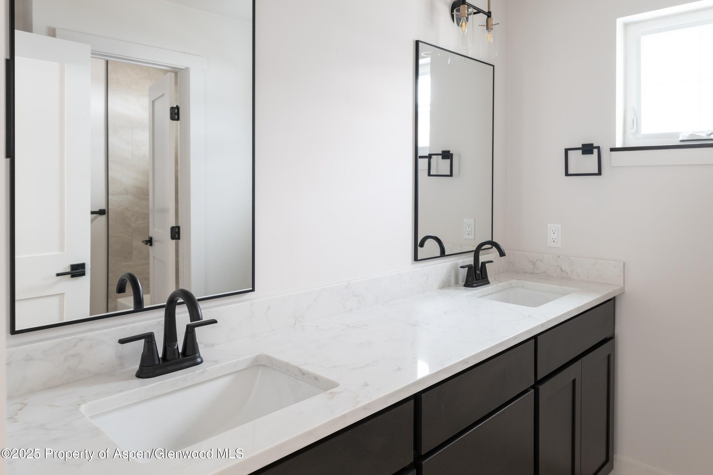 42 Mount Yale Court New Castle, CO 81647 - Photo 18 of 26 a bathroom with a sink and a mirror