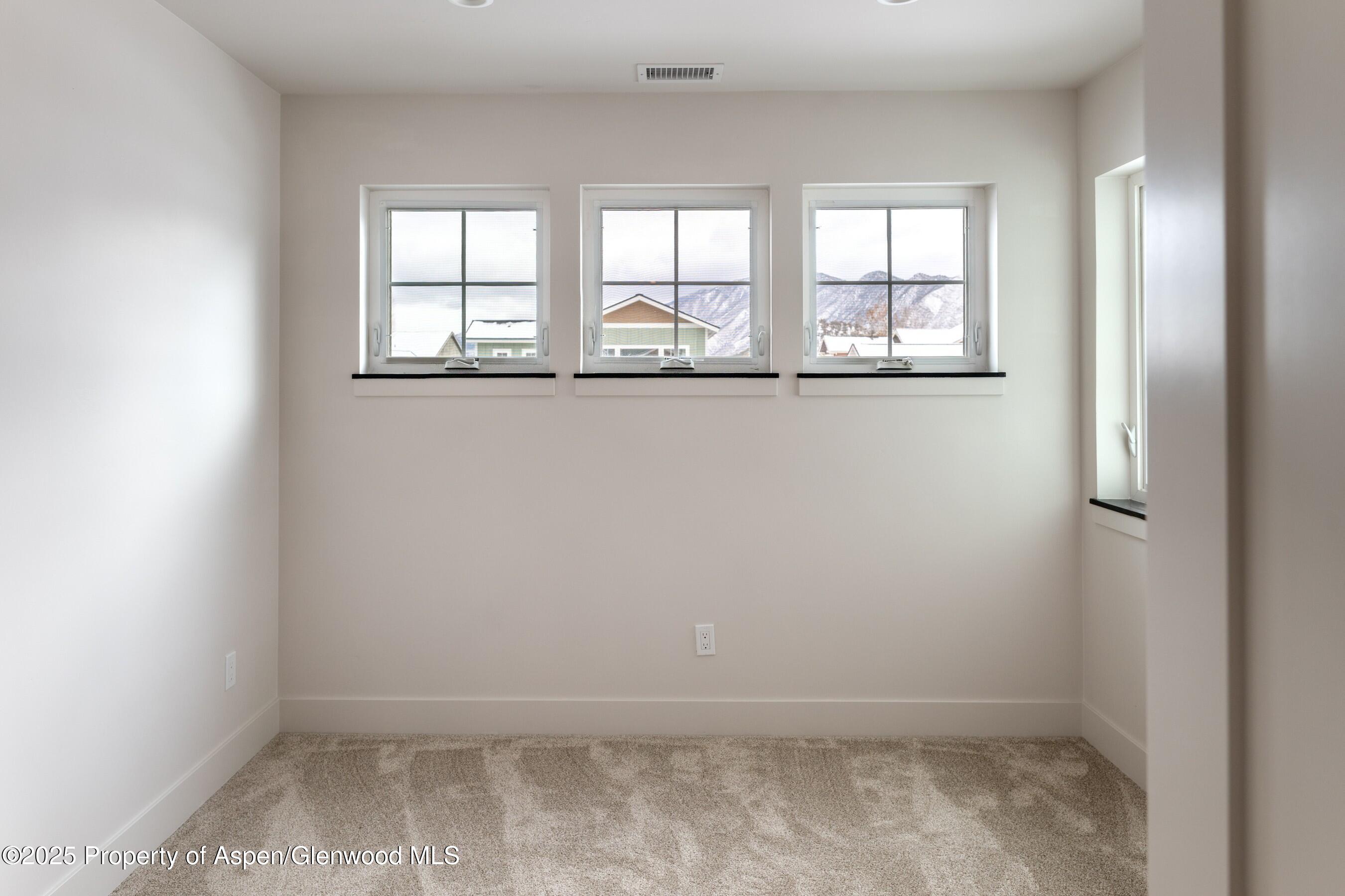 42 Mount Yale Court New Castle, CO 81647 - Photo 20 of 26 an empty room with windows