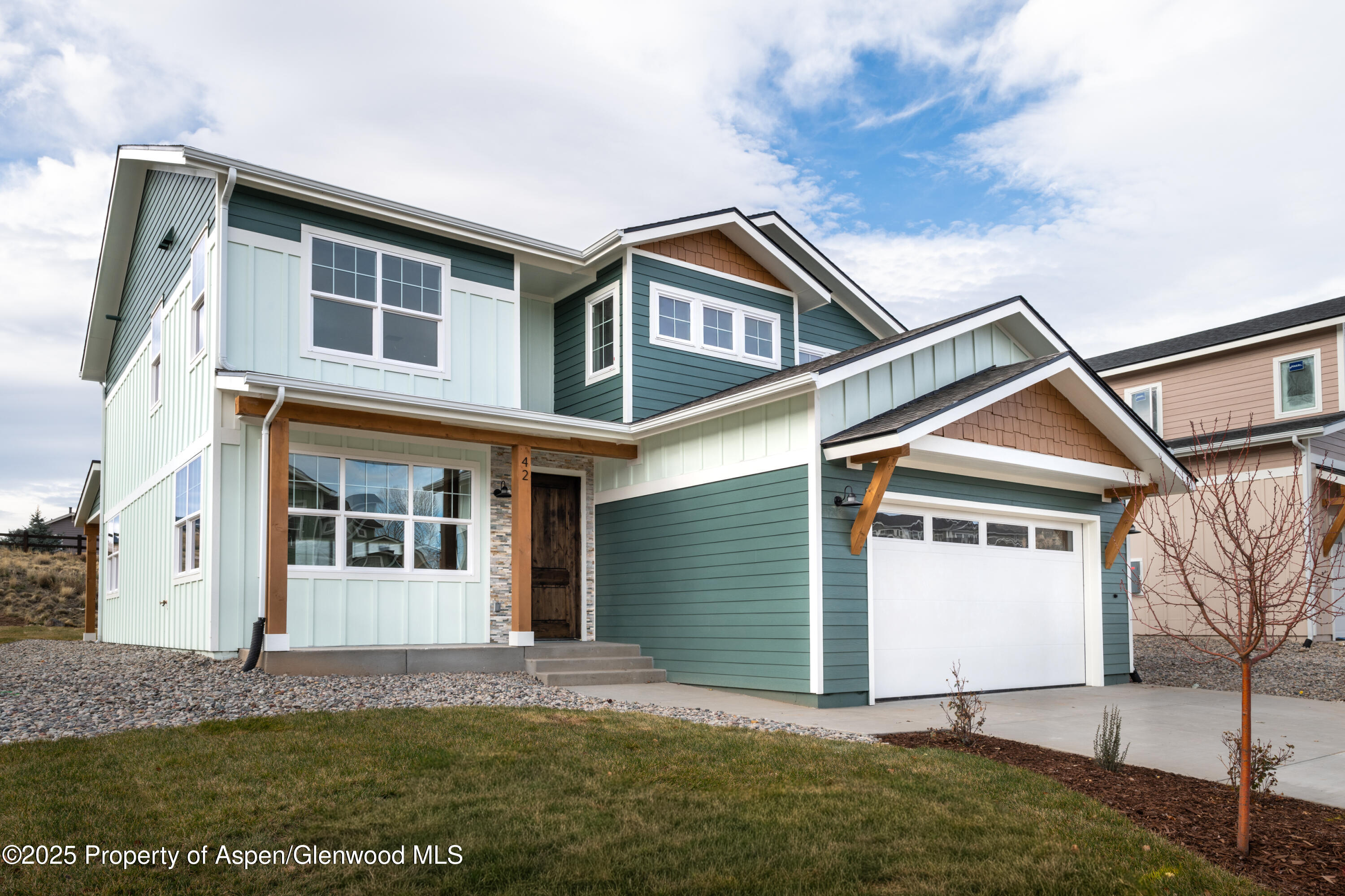42 Mount Yale Court New Castle, CO 81647 - Photo 2 of 26 a front view of a house with a yard and garage