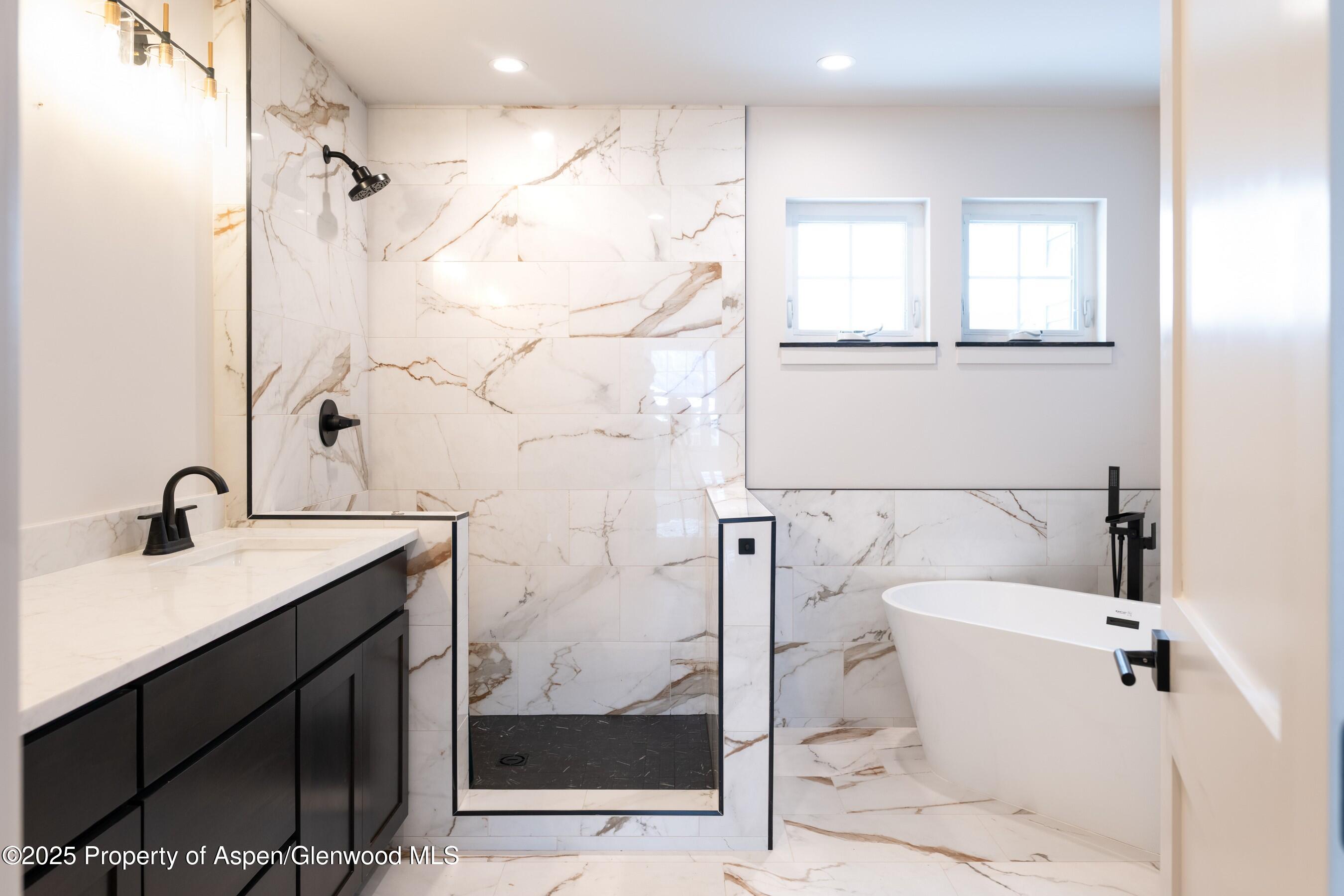 42 Mount Yale Court New Castle, CO 81647 - Photo 24 of 26 a bathroom with a granite countertop sink a toilet and shower