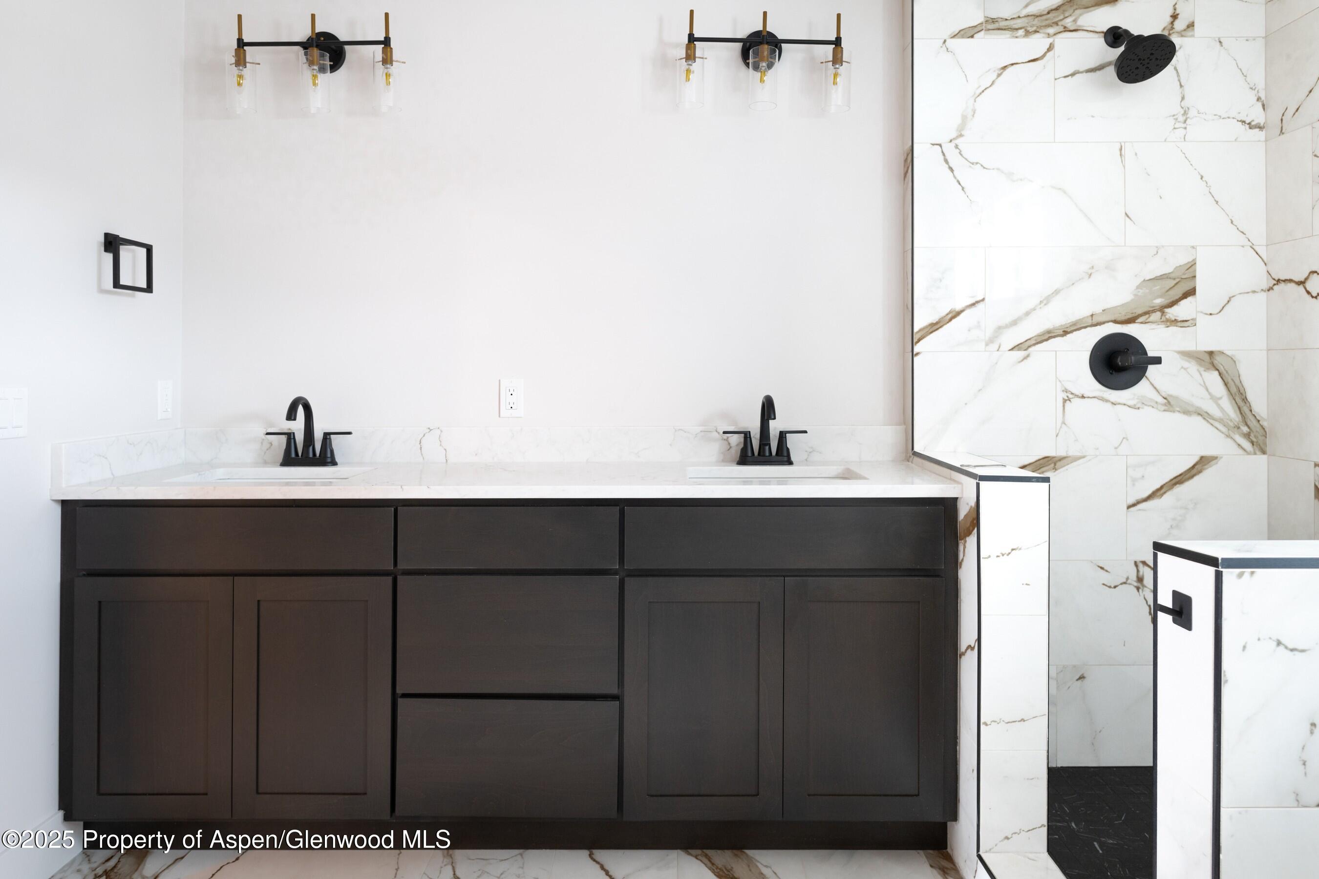 42 Mount Yale Court New Castle, CO 81647 - Photo 25 of 26 a bathroom with a sink and a mirror