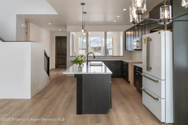 a kitchen with refrigerator and window