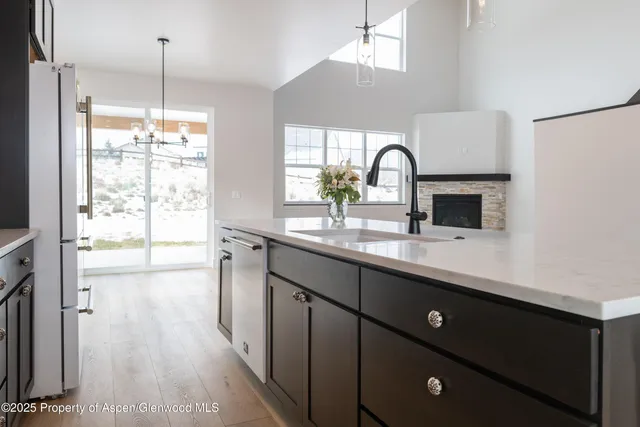 a kitchen with stainless steel appliances granite countertop a refrigerator a oven a sink and a microwave