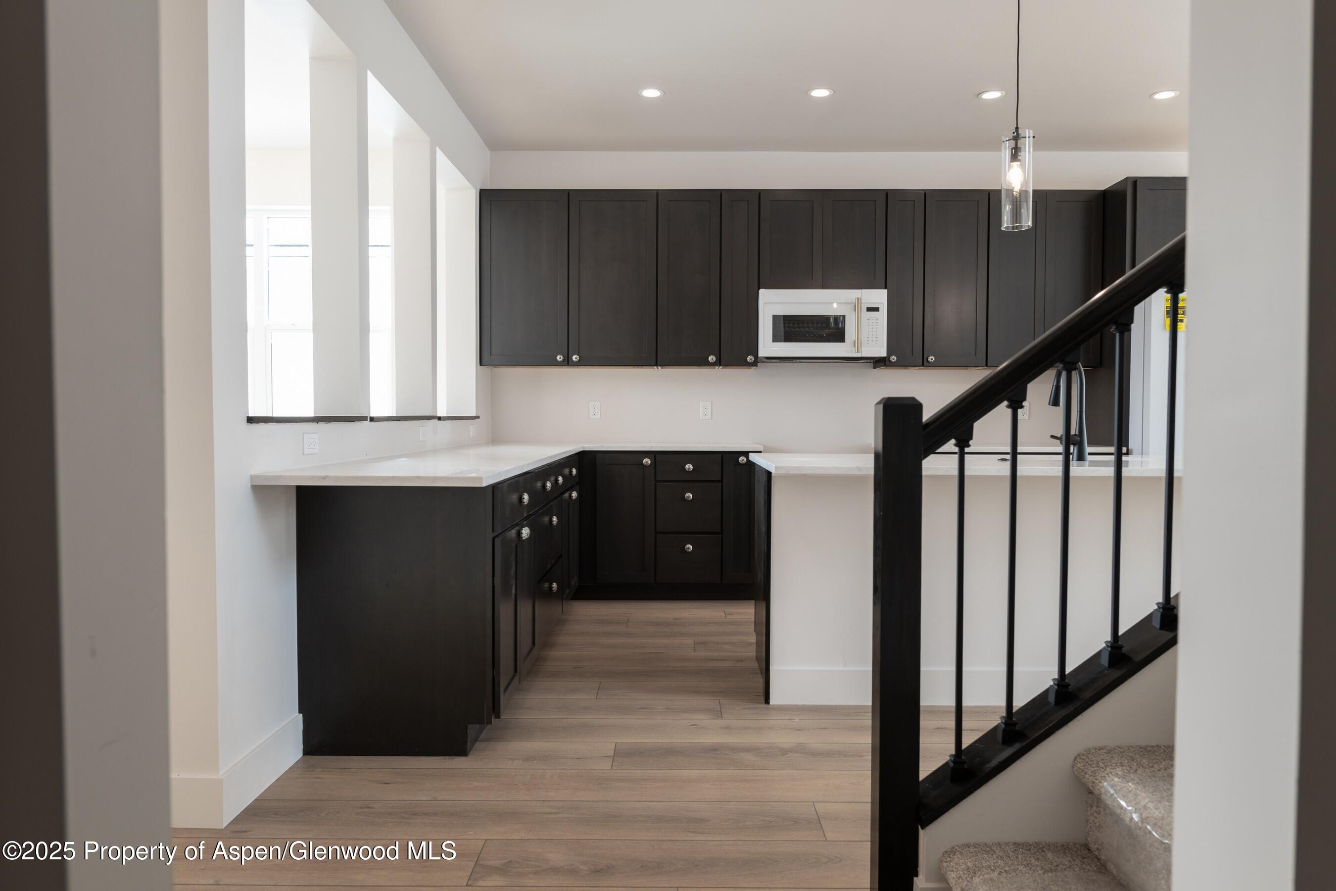 42 Mount Yale Court New Castle, CO 81647 - Photo 9 of 26 a kitchen with stainless steel appliances granite countertop a refrigerator a oven a sink and a microwave