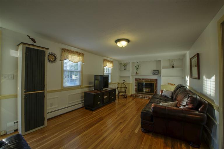 10 Goose Point Road Centerville, MA 02601 - Photo 12 of 30 a living room with furniture a fireplace a flat screen tv and a fireplace