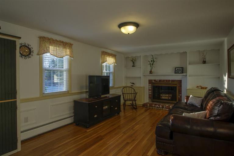 10 Goose Point Road Centerville, MA 02601 - Photo 15 of 30 a living room with furniture and a fireplace