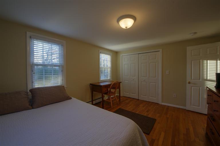 10 Goose Point Road Centerville, MA 02601 - Photo 19 of 30 a bedroom with a bed and a table in it