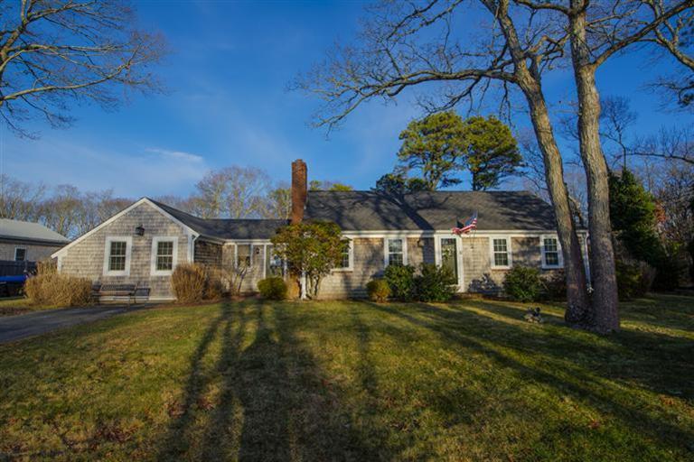 10 Goose Point Road Centerville, MA 02601 - Photo 2 of 30 a front view of a house with a garden