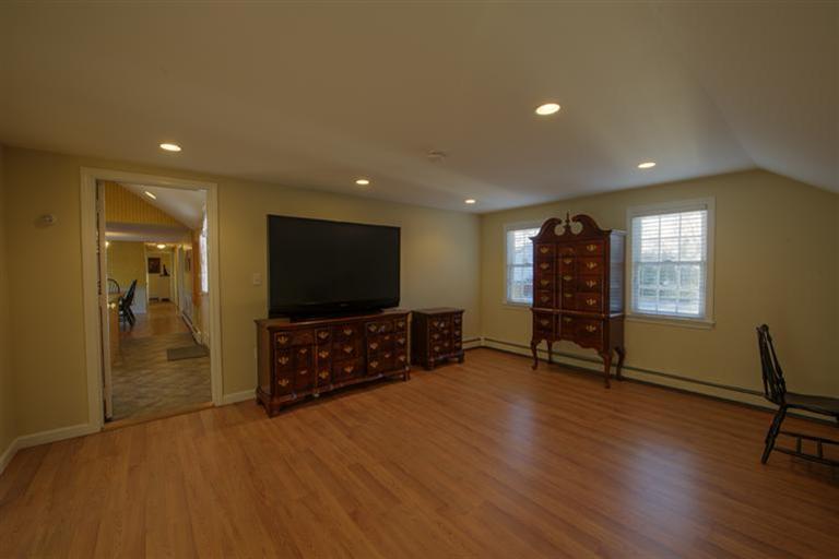 10 Goose Point Road Centerville, MA 02601 - Photo 24 of 30 an empty room with wooden floor and furniture