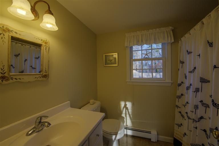 10 Goose Point Road Centerville, MA 02601 - Photo 26 of 30 a bathroom with a sink and a mirror