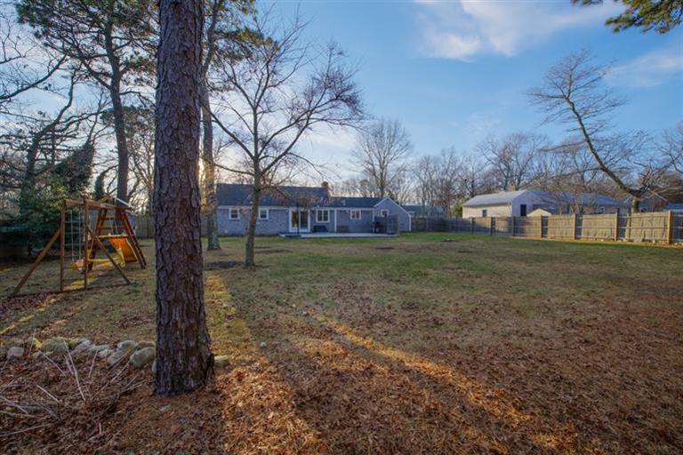 10 Goose Point Road Centerville, MA 02601 - Photo 5 of 30 a view of a yard with a house in the background