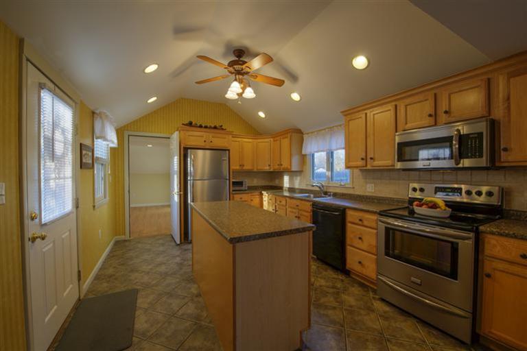 10 Goose Point Road Centerville, MA 02601 - Photo 7 of 30 a kitchen with stainless steel appliances granite countertop a refrigerator a stove top oven a sink and dishwasher