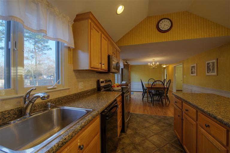 10 Goose Point Road Centerville, MA 02601 - Photo 8 of 30 a kitchen with a sink and chairs