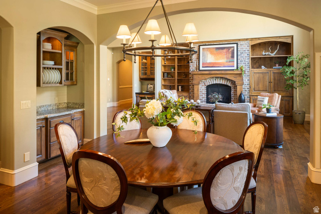 875 South 1250th Street East Mapleton, UT 84664 - Photo 27 of 54 Formal dining area featuring a round wood-finish table, a decorative chandelier, and crown molding