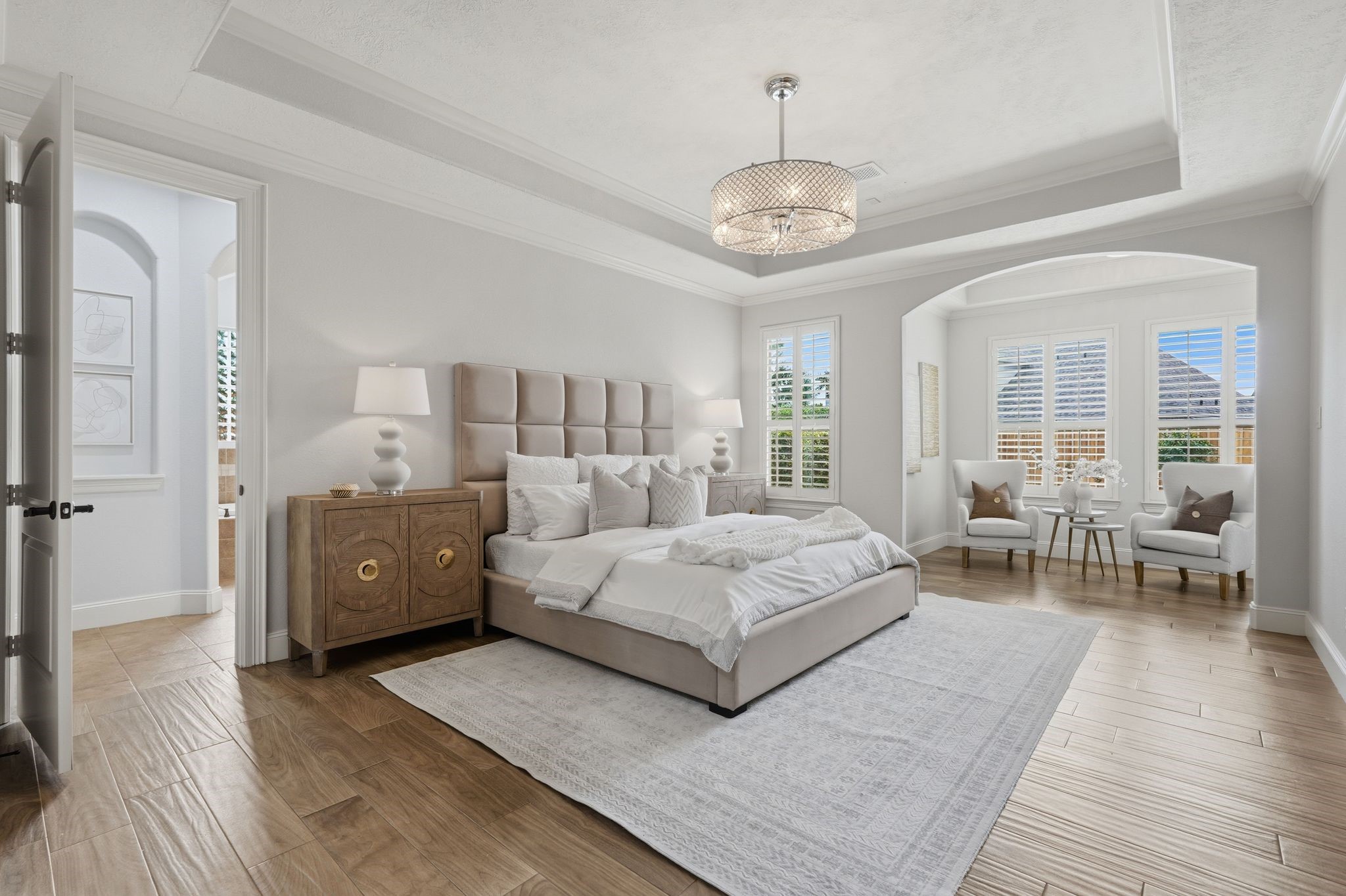 7603 Hogan Bridge Court Spring, TX 77389 - Photo 16 of 50 A true retreat! This expansive primary suite is elevated by tray ceilings, bathed in natural light, and framed by plantation shutters, creating a space that feels both luxurious and effortlessly serene.
