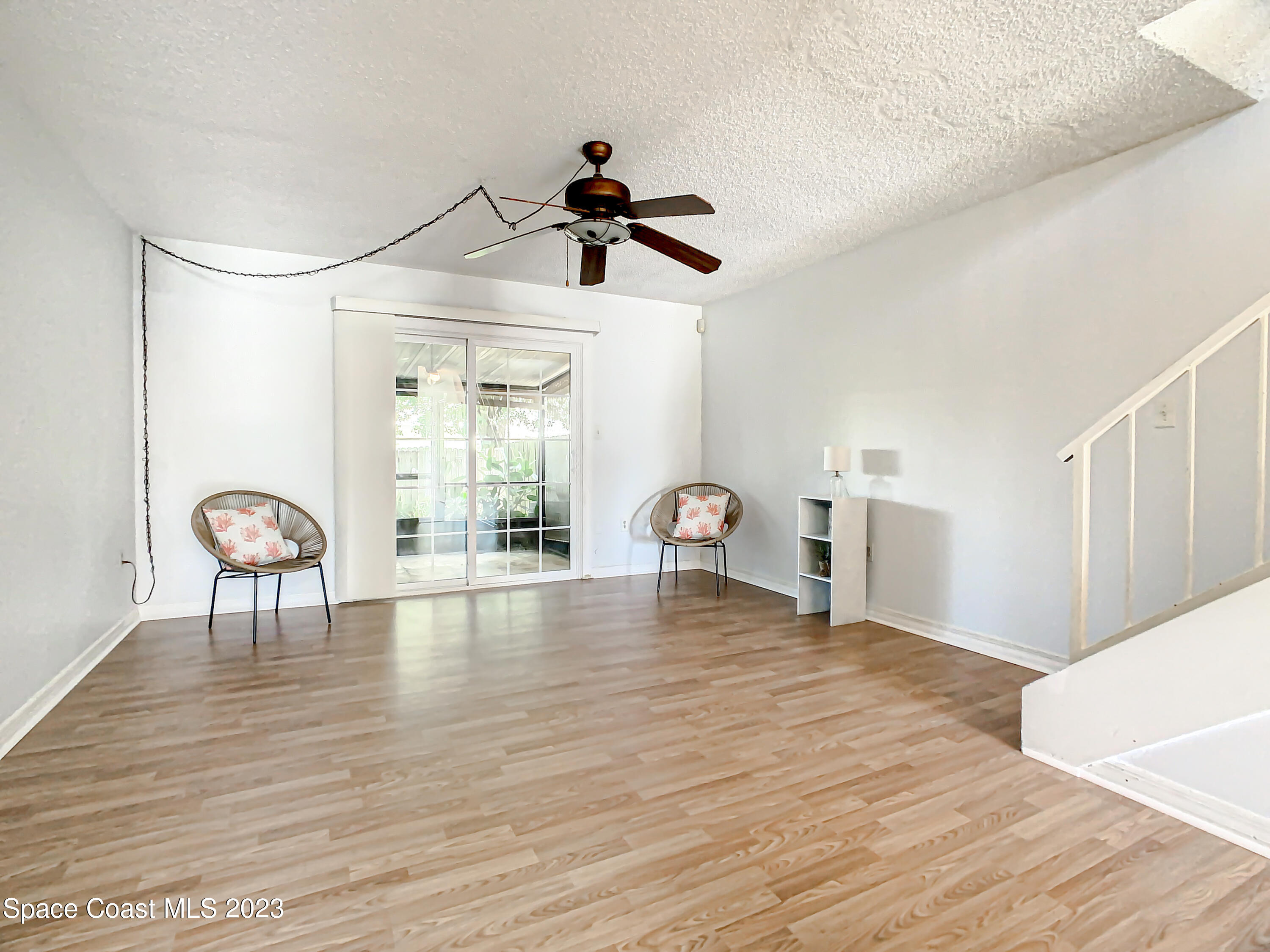 4859 Sisson Road Titusville, FL 32780 - Photo 13 of 30 a view of empty room with wooden floor and fan