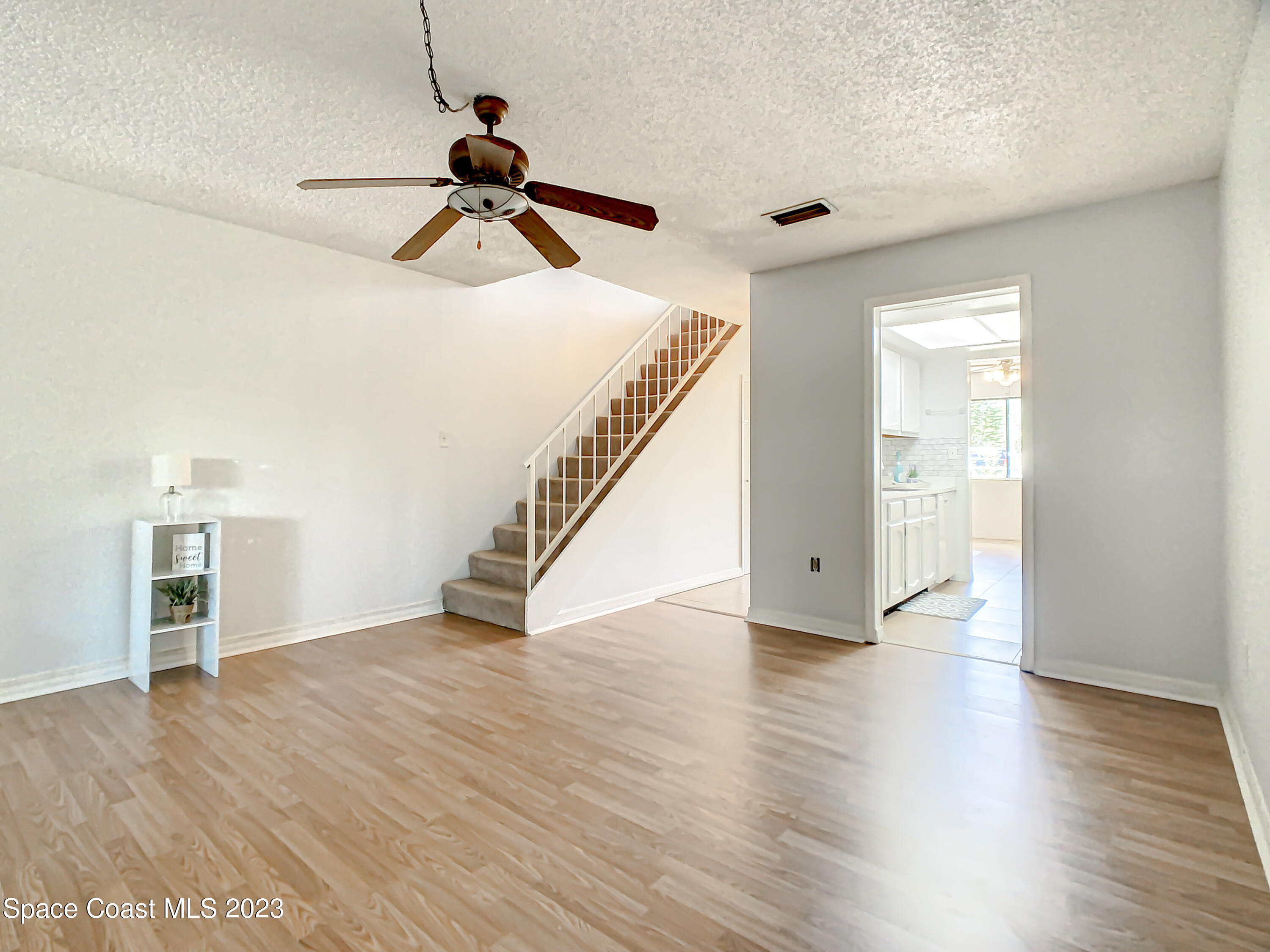 4859 Sisson Road Titusville, FL 32780 - Photo 14 of 30 a view of empty room with wooden floor and ceiling fan