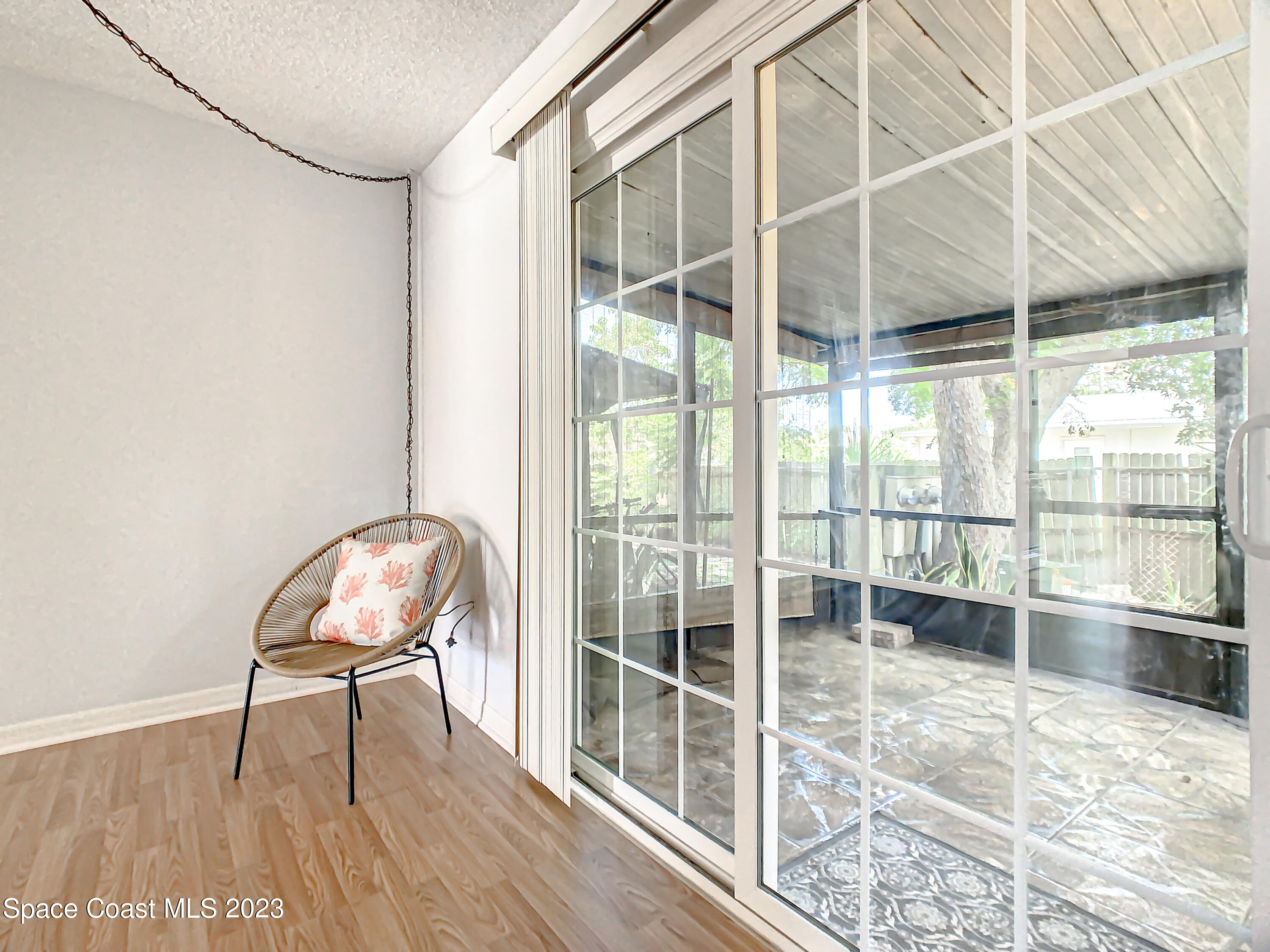 4859 Sisson Road Titusville, FL 32780 - Photo 15 of 30 a room with a chair and a floor to ceiling window