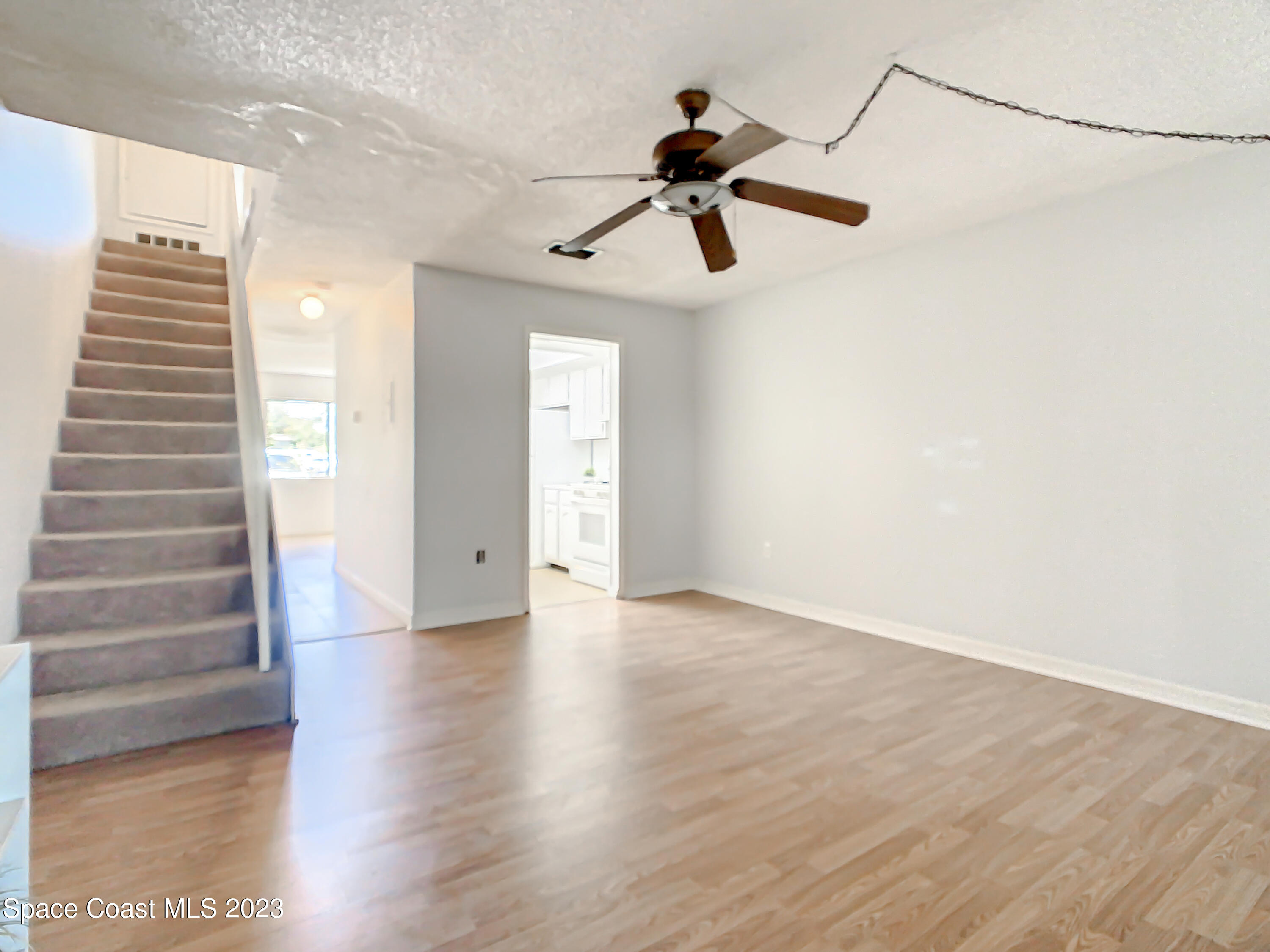 4859 Sisson Road Titusville, FL 32780 - Photo 16 of 30 a view of an empty room with a window and wooden floor