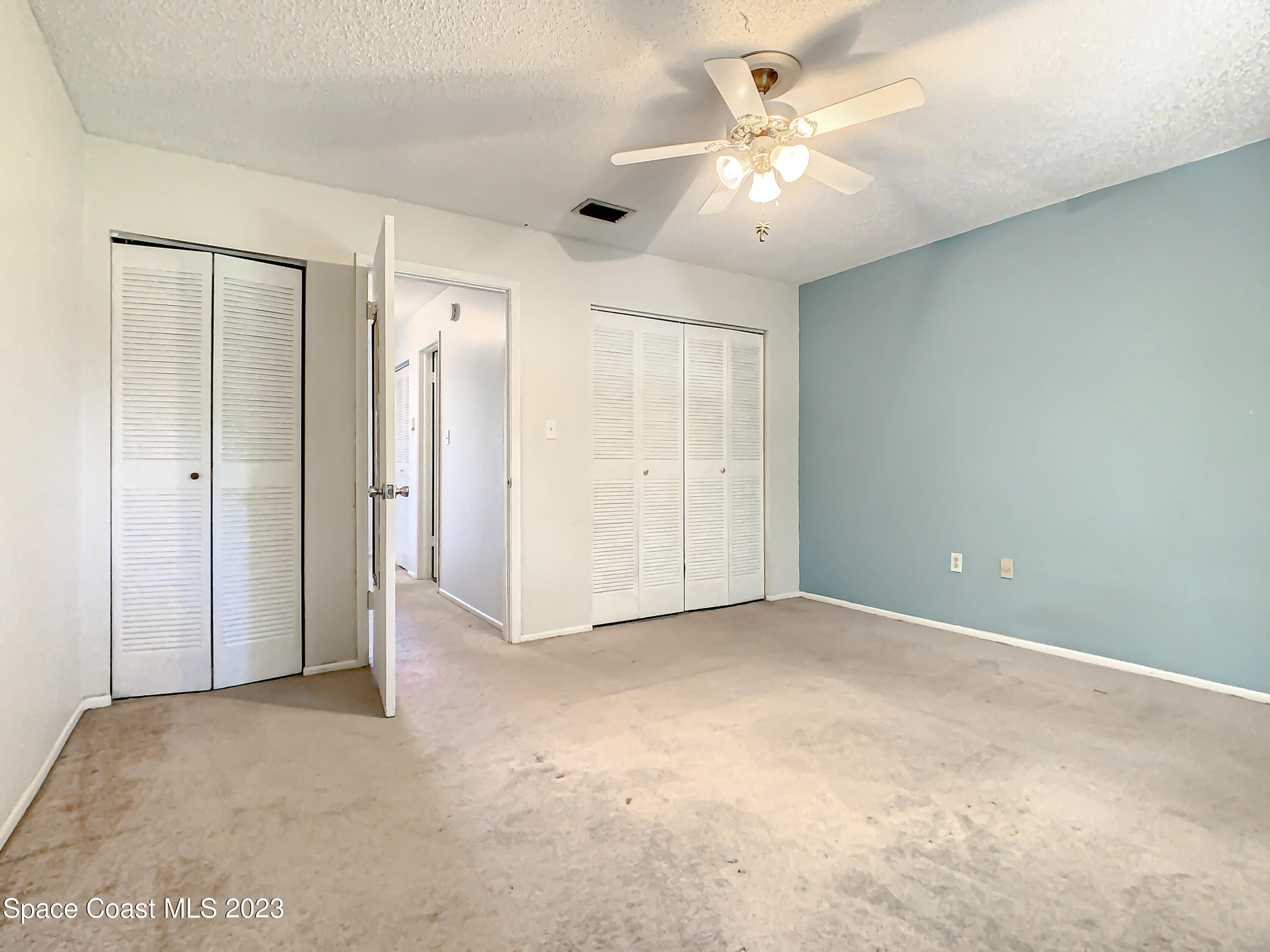 4859 Sisson Road Titusville, FL 32780 - Photo 19 of 30 an empty room with fan and a ceiling fan