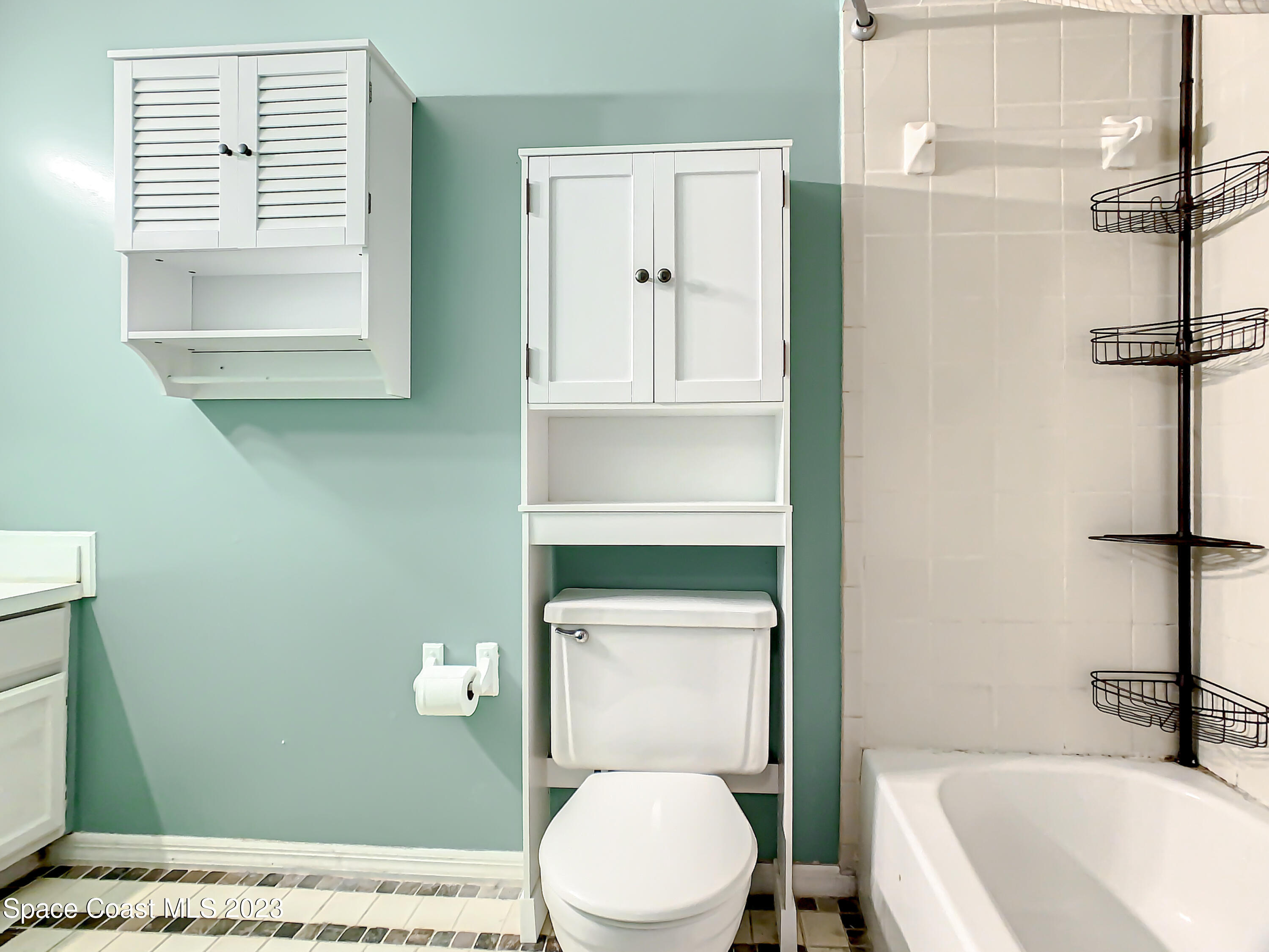 4859 Sisson Road Titusville, FL 32780 - Photo 21 of 30 a bathroom with a toilet a sink and mirror