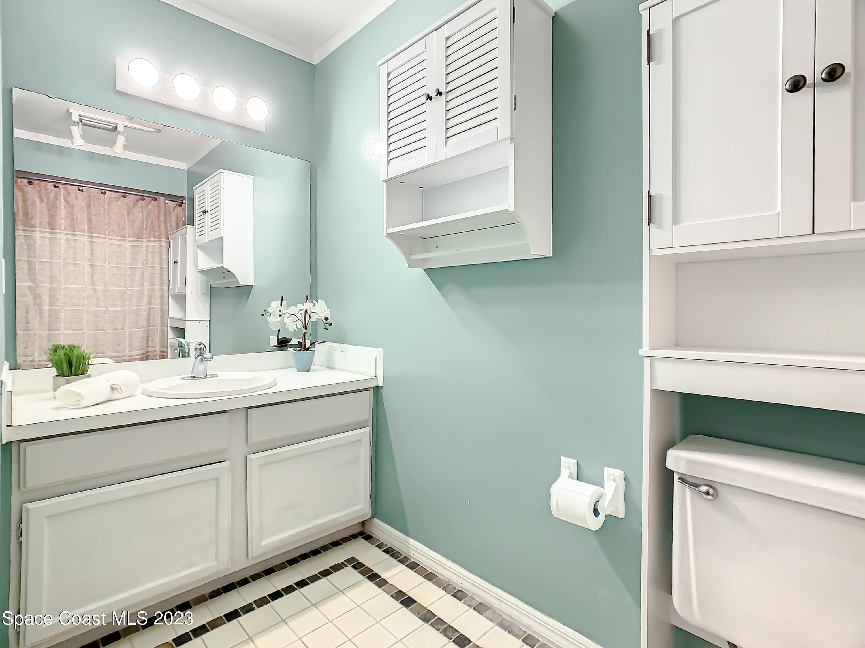 4859 Sisson Road Titusville, FL 32780 - Photo 22 of 30 a bathroom with a sink and a mirror
