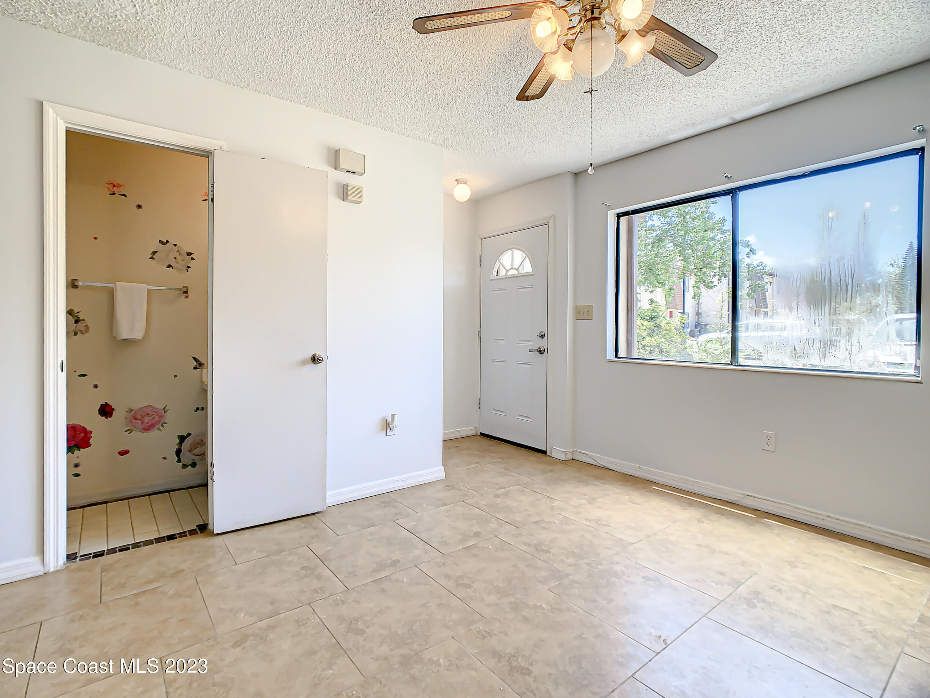 4859 Sisson Road Titusville, FL 32780 - Photo 4 of 30 a view of an empty room with a window